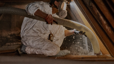 A person installing installation with safety equipment on